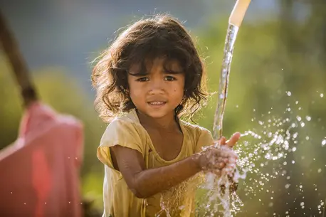 Pinang Thi Thuy, Raglai ethnic minority 5 years girl, enjoys her family's clean water source in Bac Ai, Phuoc Hoa, Ninh Thuan. Thuy's family was suffered great crop failure due to the historical drought in Viet Nam, 2015-2016. In addition her younger brot