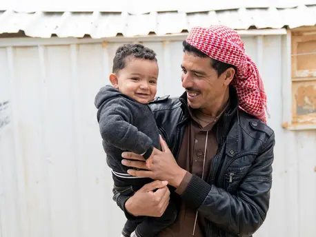 Syrian refugee Shaheen holds his 1-year-old son, Mohammad, in Jordan's Azraq refugee camp. Mohammad was born in the camp's UNICEF-supported pediatric ward. Syrian refugee Shaheen holds his 1-year-old son, Mohammad, in Jordan's Azraq refugee camp. Mohammad was born in the camp's UNICEF-supported pediatric ward.