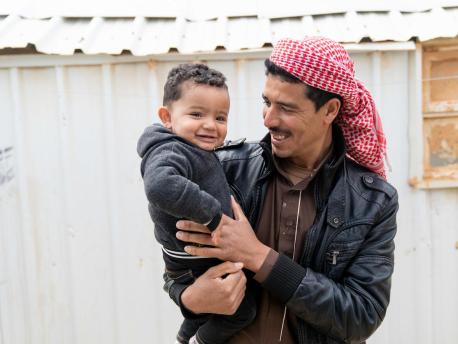 Syrian refugee Shaheen holds his 1-year-old son, Mohammad, in Jordan's Azraq refugee camp. Mohammad was born in the camp's UNICEF-supported pediatric ward.