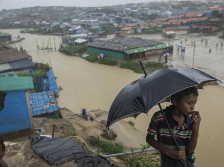 Nine-year-old Mohamed looks out over one of the canals running through Kutapalong refugee camp in Cox's Bazar, Bangladesh on July 6, 2019. Two bridges nearby were swept away by heavy monsoon rains. 