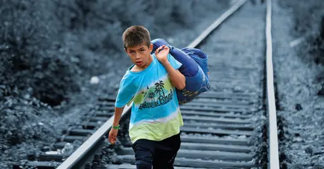 A Syrian refugee crossing into Serbia. A Syrian refugee crossing into Serbia.