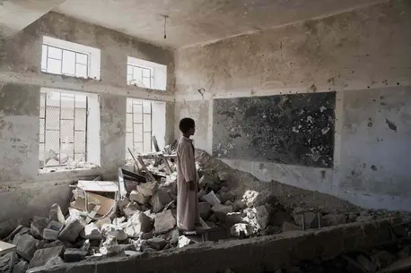 A student stands in the ruins of one of his former classrooms, which was destroyed in June 2015, at the Aal Okab school in Saada, Saada Governorate, Yemen, Monday 24 April 2017. Students now attend lessons in UNICEF tents nearby, A student stands in the ruins of one of his former classrooms, which was destroyed in June 2015, at the Aal Okab school in Saada, Saada Governorate, Yemen, Monday 24 April 2017. Students now attend lessons in UNICEF tents nearby,