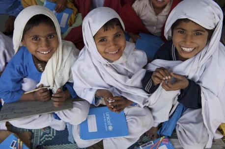 Children smile while attending school in a UNICEF-supported Temporary Learning Centre (TLC) in the village of Basti Bhaya in Rajanpur, amongst one of the worst affected district in Punjab province. 