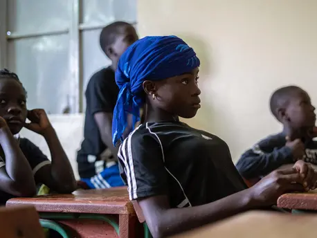 A UNICEF-supported program linking soccer and academics in Niamey, Niger keeps teenagers like Pascaline in school. A UNICEF-supported program linking soccer and academics in Niamey, Niger keeps teenagers like Pascaline in school.