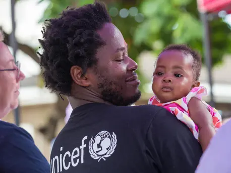 Ishmael Beah, author, former child soldier and UNICEF Advocate for Children Affected by War, holds a baby girl during a visit to Ola During Children's Hospital in Freetown, Sierra Leone, on 17 November 2019. Ishmael Beah, author, former child soldier and UNICEF Advocate for Children Affected by War, holds a baby girl during a visit to Ola During Children's Hospital in Freetown, Sierra Leone, on 17 November 2019.