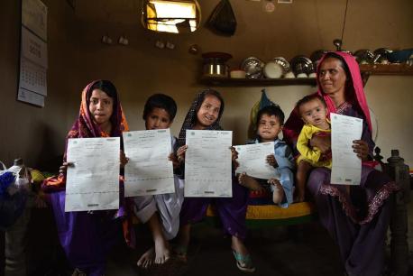 A mother in Pakistan with her five children, all of whom were recently registered and issued birth certificates using a new digital registration service launched by Telenor Pakistan in partnership with UNICEF.