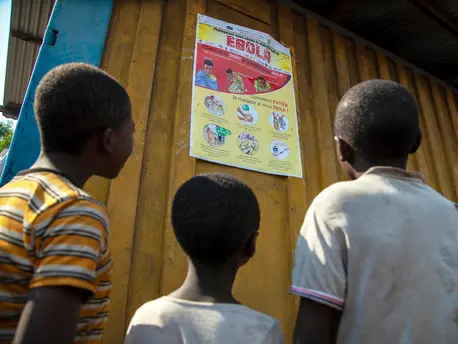 Children read an Ebola-awareness poster in North Kivu, the Democratic Republic of the Congo (DRC). Children read an Ebola-awareness poster in North Kivu, the Democratic Republic of the Congo (DRC).