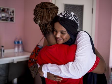 Born a refugee herself, UNICEF Ambassador Halima Aden hugs a young asylum seeker at a UNICEF-supported reception center in Palermo, Italy on August 7, 2019.