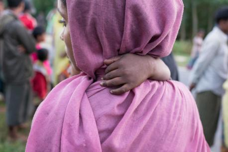 A Rohingya refugee mother and baby on the shores of Bangladesh after crossing by boat from Myanmar to escape genocidal violence.