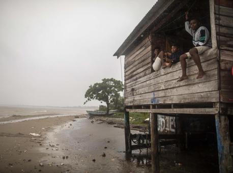 Children sit on a beach house window ledge as Hurricane Eta approaches in Bilwi, Puerto Cabezas, Nicaragua, on November 2, 2020. 