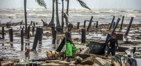 Two boys in Bilwi, Nicaragua, search for scraps of wood to help their parents rebuild their house after it was destroyed by the strong winds and rains brought by Hurricane Iota. Two boys in Bilwi, Nicaragua, search for scraps of wood to help their parents rebuild their house after it was destroyed by the strong winds and rains brought by Hurricane Iota.