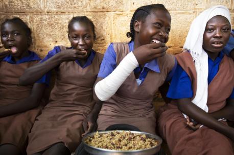 A group of students take their lunch at the Wau A Girls Primary School in Wau, South Sudan, as part of the Feeding Program run by WFP and UNICEF and funded by the European Union (EU).