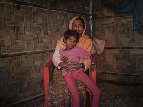 On 2 December 2019, Anjuma Bengum, 30, holds her daughter Lala Bibi, 5, at their home in Balukhali refugee camp in Cox’s Bazar, Bangladesh. Anjuma’s second daughter, Asma, 9, disappeared while on her way to buy groceries in the market. On 2 December 2019, Anjuma Bengum, 30, holds her daughter Lala Bibi, 5, at their home in Balukhali refugee camp in Cox’s Bazar, Bangladesh. Anjuma’s second daughter, Asma, 9, disappeared while on her way to buy groceries in the market.