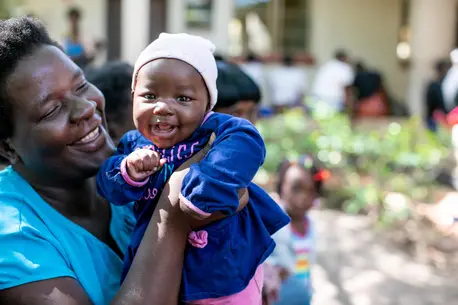 Person Holding Smiling Baby