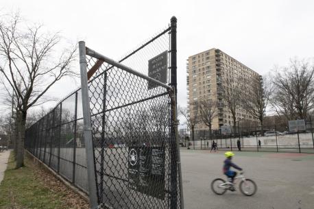 On 17 March 2020, a child rides a bike through an empty playground outside of Public School 24 in the Riverdale neighbourhood of the Bronx, New York City, United States of America.