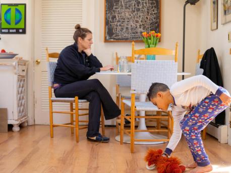 On the morning of 18 March 2020 in Connecticut, Luka, 8, plays with stuffed animals in between completing school exercises on his third day of distance learning from home, while his mother, Sophia, works on her computer.