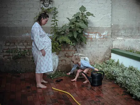 Pregnant Woman Playing with Child