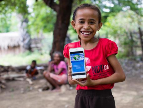 On April 14, 2020, a girl shows the online platform on which children and parents in Timor-Leste can find resources to help children continue their educations at home during the COVID-19 crisis. 