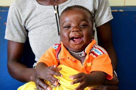 Soro Issuf, a 5 months old happy boy is waiting for his turn for being vaccinated, in the Regional Hospital of Korhogo, in the North of Côte d'Ivoire.