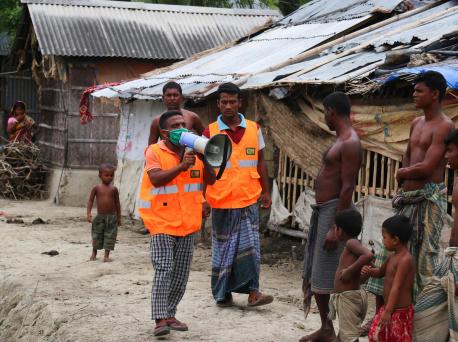 A UNICEF-supported Cyclone Preparedness Program (CPP) volunteer uses a megaphone to urge residents to evacuate to shelters ahead of the expected landfall of cyclone Amphan in Khulna, Bangladesh on May 19, 2020.