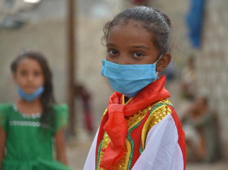 Seven-year-old Jabra wears a mask to prevent transmission of the novel coronavirus in Yemen in 2020.