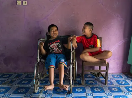 Syaiful (left), 12, a child with a physical impairment, sits next to his best friend, Kevin, 9, a child with a visual impairment, in Banyumas, Central Java, Indonesia. The boys attend a UNICEF-supported inclusive education program. Syaiful (left), 12, a child with a physical impairment, sits next to his best friend, Kevin, 9, a child with a visual impairment, in Banyumas, Central Java, Indonesia. The boys attend a UNICEF-supported inclusive education program.