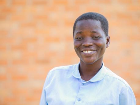 Nelia, 18, is on track to receive her secondary school diploma at Mpamba Community Day Secondary School in Nkhatabay District, Malawi, with help from a scholarship provided by the Kids in Need of Desks (K.I.N.D.) Fund.
