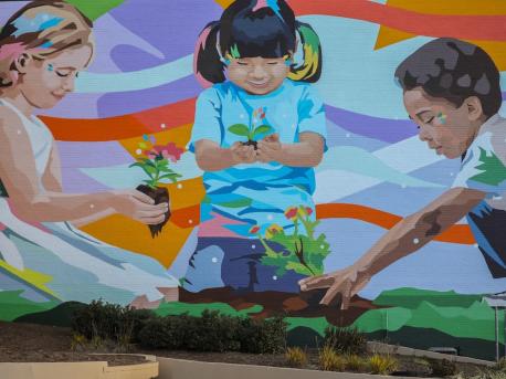 Painted by the artist Daas in 2020, a mural in downtown Johnson City, Tenn., features three children planting the seeds for a future rich in diversity and racial equality. 