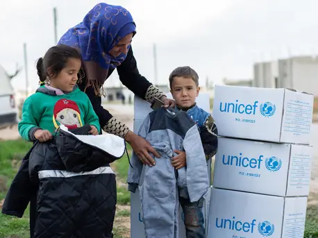 Women and Children with UNICEF Boxes