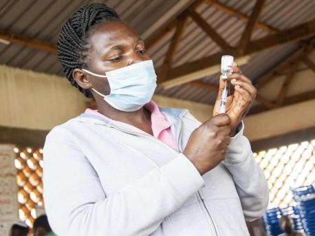 n Uganda on October 19, 2021, Mary Namirembe, a nurse at Masaka Regional Referral Hospital, fills a syringe with COVID-19 vaccine. 