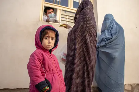 Parwana, 4, with caregivers, outside the UNICEF-supported clinic where she is receiving treatment for severe acute malnutrition. Parwana, 4, with caregivers, outside the UNICEF-supported clinic where she is receiving treatment for severe acute malnutrition.