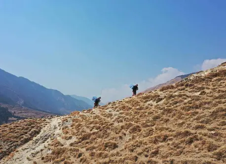 People Hiking Up a Hill