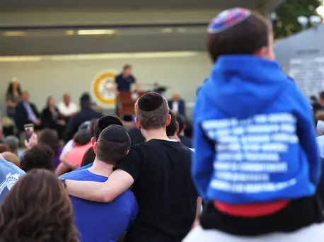 People listen to Joseph Borgen, a recent victim of a hate crime, speak during a rally denouncing antisemitic violence on May 27, 2021 in Cedarhurst, New York. People listen to Joseph Borgen, a recent victim of a hate crime, speak during a rally denouncing antisemitic violence on May 27, 2021 in Cedarhurst, New York.