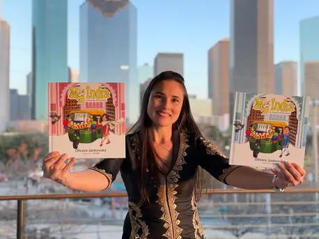 Woman Holding Up Childrens Books