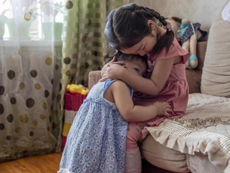 On May 20, 2019, Uuriintsolmon Erdenejargal, 1, cuddles with her older sister, Gunjidmaa Nyambat, 5, at their home in Murun, Khövsgöl province, Mongolia.