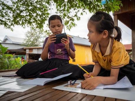 When their school was closed to prevent the spread of COVID-19, Kvas Em and Rocham Yhang kept up with their lessons via a radio provided by UNICEF in Paor Kekchong village, Borkeo District, Rattanakiri, Cambodia.