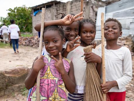 A group of young children from Kinshasa, Democratic Republic of the Congo, pause their clean-up activities to take a photo. The group, who range in age from 4 to 18, meet every Saturday morning to remove waste and discarded debris from their neighborhoods