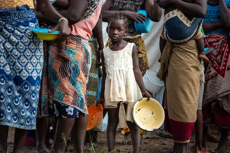 Displaced children and families queue for food at a relief distribution point outside the port city of Beira, where Cyclone Eloise made landfall on Jan. 23. Displaced children and families queue for food at a relief distribution point outside the port city of Beira, where Cyclone Eloise made landfall on Jan. 23.