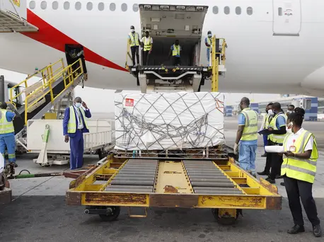 On 24 February 2021, staff unloads the first shipment of COVID-19 vaccines distributed by the COVAX Facility at the Kotoka International Airport in Accra, Ghana's capital. On 24 February 2021, staff unloads the first shipment of COVID-19 vaccines distributed by the COVAX Facility at the Kotoka International Airport in Accra, Ghana's capital.
