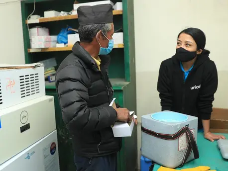 Mitthi Jirel (left), staff at the district hospital in Jiri in Dolakha District in northeastern Nepal, with UNICEF staff Preena Shrestha (right) in the hospital's vaccine storage room on February 26, 2021. Mitthi Jirel (left), staff at the district hospital in Jiri in Dolakha District in northeastern Nepal, with UNICEF staff Preena Shrestha (right) in the hospital's vaccine storage room on February 26, 2021.
