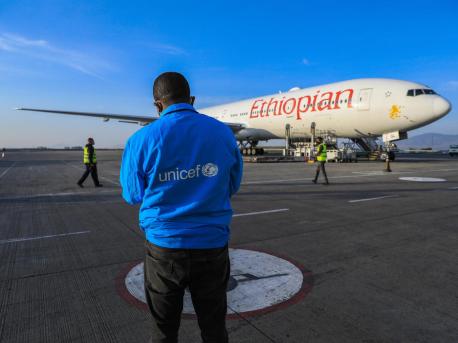 Man in UNICEF Jacket in Front of Ethiopian Airplane