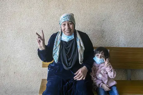 Woman and Child Holding Up Peace Signs