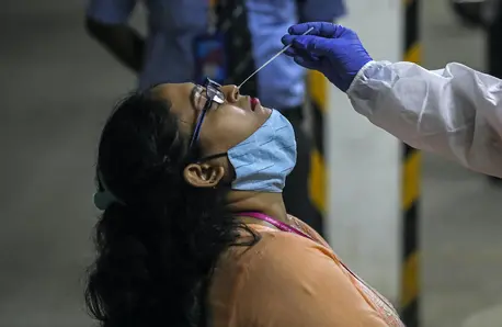 A health worker takes a nasal swab sample to test for COVID-19 at a facility in the Malad area of Mumbai, India, on April 30, 2021. A health worker takes a nasal swab sample to test for COVID-19 at a facility in the Malad area of Mumbai, India, on April 30, 2021.