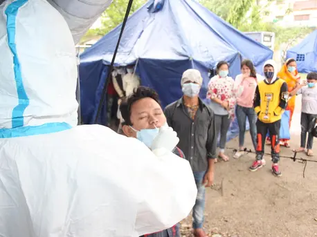 On May 5, 2021, individuals and families make the crossing from India into Nepal at the Birgunj point of entry in Parsa District in southern Nepal, where they are met by border personnel and health workers for temperature checks and antigen tests. On May 5, 2021, individuals and families make the crossing from India into Nepal at the Birgunj point of entry in Parsa District in southern Nepal, where they are met by border personnel and health workers for temperature checks and antigen tests.