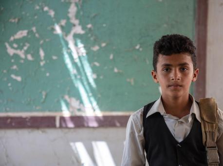 Twelve-year-old Ahmed standing in his classroom in Al-Hamzi school, which was damaged by the conflict in 2015, in Yemen's Hajjah governorate, March 2021.