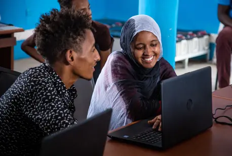 Two People on Laptops