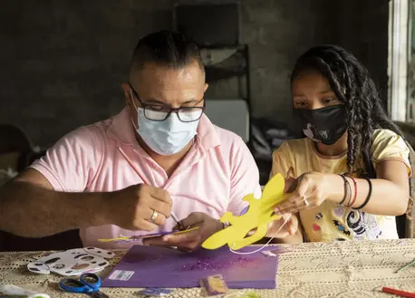 Man and Child Doing Arts and Crafts