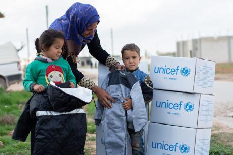 Women and Children with UNICEF Boxes