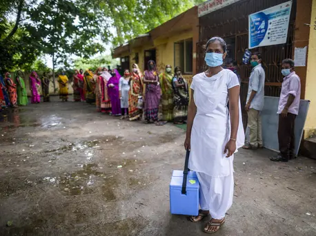 Nilam Bamaniya, a 23-year-old general nursing midwife, holds a vaccine carrier filled with vaccine doses for a COVID-19 vaccination session at a UNICEF-supported public health center in Samlaya, Vadodra, Gujarat, India on July 20. 2021. Nilam Bamaniya, a 23-year-old general nursing midwife, holds a vaccine carrier filled with vaccine doses for a COVID-19 vaccination session at a UNICEF-supported public health center in Samlaya, Vadodra, Gujarat, India on July 20. 2021.