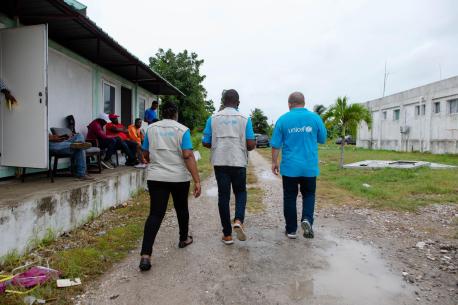 UNICEF representatives walk through the courtyard of Ofatma Hospital in Les Cayes, Haiti, on 17 August 2021. UNICEF installed tents in the courtyard shelter patients and their families who feared the hospital building could collapse.